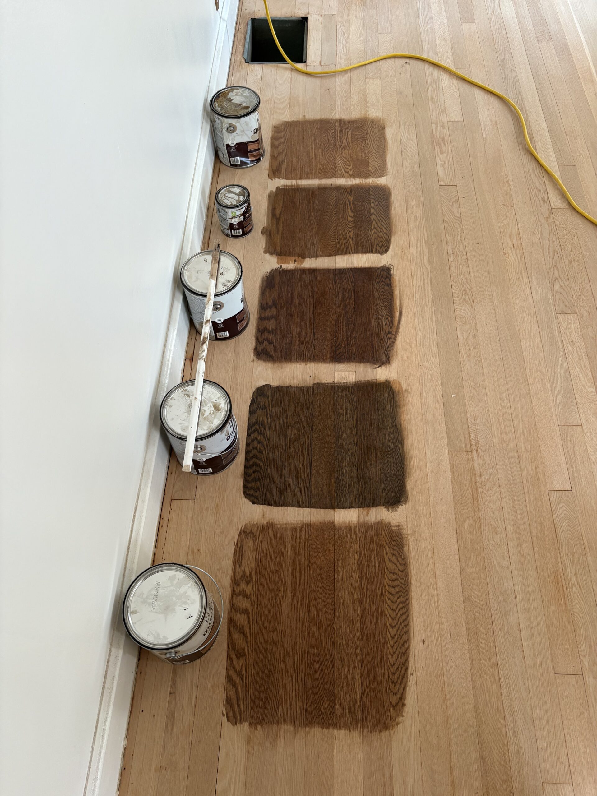 Paint cans on a wood floor.